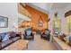 Bright living room with vaulted ceilings, leather furniture, and an open floor plan to kitchen and dining area at 33 Broken Lance Dr # 207S, Breckenridge, CO 80424