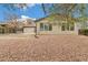 Backyard featuring desert landscaping, mature trees, and a privacy fence providing shade at 180 W 78Th Pl, Denver, CO 80221