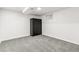 Bedroom with gray carpet, white walls, and black storage cabinet and a small window at 180 W 78Th Pl, Denver, CO 80221