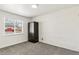 Cozy bedroom with gray carpet, white brick wall, and natural light from the window at 180 W 78Th Pl, Denver, CO 80221