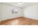 Bedroom with a bright window and hardwood floors at 180 W 78Th Pl, Denver, CO 80221