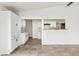 Open-concept kitchen with white cabinetry, marble countertops, and a breakfast bar overlooking the living area at 180 W 78Th Pl, Denver, CO 80221