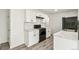 Modern kitchen featuring white cabinets, marble countertops, subway tile backsplash, and black appliances at 180 W 78Th Pl, Denver, CO 80221