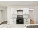 Modern kitchen featuring white cabinets, marble countertops, subway tile backsplash, and black appliances at 180 W 78Th Pl, Denver, CO 80221
