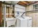 Laundry room with a sink, washer, dryer, and shelving for storage at 180 W 78Th Pl, Denver, CO 80221