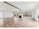 Bright living room features a fireplace, large windows, and beam ceiling at 180 W 78Th Pl, Denver, CO 80221