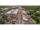 An aerial view of a street with multi-story apartment buildings, interspersed with commercial space, retail, and greenery at 2244 S Lincoln St, Denver, CO 80210