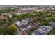 An aerial view of homes, solar panels, lush trees, and modern architecture in a well-planned neighborhood at 2244 S Lincoln St, Denver, CO 80210