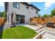 Spacious backyard with grassy area, patio with dining table, and outdoor grill, great for entertaining at 2244 S Lincoln St, Denver, CO 80210