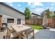 Backyard featuring an outdoor dining table, grassy area, and privacy fence, perfect for summer gatherings at 2244 S Lincoln St, Denver, CO 80210