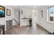 A stylish bar area includes sleek cabinetry, a beverage fridge, and is located next to stairs and an open space at 2244 S Lincoln St, Denver, CO 80210