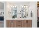 Well-lit bathroom features a double vanity with modern fixtures and a view into the walk-in closet at 2244 S Lincoln St, Denver, CO 80210