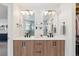 Well-lit bathroom features a double vanity with modern fixtures and a view into the walk-in closet at 2244 S Lincoln St, Denver, CO 80210