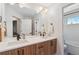 Stylish bathroom featuring a double sink vanity with a large mirror and modern fixtures at 2244 S Lincoln St, Denver, CO 80210