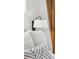 Bedroom close-up highlighting stylish pillows, bedding, a bedside lamp, and curtains for a cozy feel at 2244 S Lincoln St, Denver, CO 80210