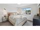 Bright bedroom featuring a plush bed, side tables, and ample natural light from a large window at 2244 S Lincoln St, Denver, CO 80210