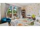 Bright bedroom with a sliding glass door to a patio, and playful polka dot wall design, creating a cozy retreat at 2244 S Lincoln St, Denver, CO 80210