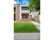 Modern two-story home featuring a red brick facade, white accents, a well-manicured lawn and an inviting front terrace at 2244 S Lincoln St, Denver, CO 80210
