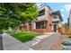 Stylish two-story residence featuring red brick accents, a well-maintained lawn, and a charming front terrace at 2244 S Lincoln St, Denver, CO 80210