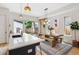 Bright kitchen with a wooden dining table, white countertops, stainless steel appliances, and view of backyard at 2244 S Lincoln St, Denver, CO 80210