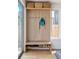 Mudroom with wooden bench and storage for shoes, hooks and baskets for jackets and gear at 2244 S Lincoln St, Denver, CO 80210