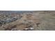 Panoramic aerial shot showcasing a residential area bordering a natural habitat with dry grasslands and hills at 2578 Gray Wolf Pl, Castle Rock, CO 80104