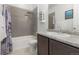 Bathroom features a shower-tub combination, single sink with granite countertop, and neutral colored tile flooring at 2578 Gray Wolf Pl, Castle Rock, CO 80104