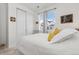 Well-lit bedroom with a large window, closet with sliding doors, and comfortable bed with decorative pillows at 2578 Gray Wolf Pl, Castle Rock, CO 80104