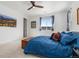 Bright primary bedroom featuring a large bed, art and ample light at 2578 Gray Wolf Pl, Castle Rock, CO 80104