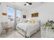 Bright bedroom features a large window, white furniture, neutral carpet, horse painting, and plant at 2578 Gray Wolf Pl, Castle Rock, CO 80104