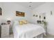 Cozy bedroom featuring a comfortable bed, woven mirror, a plant and neutral carpet at 2578 Gray Wolf Pl, Castle Rock, CO 80104