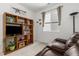 Relaxing bonus room with comfortable seating, built-in shelving, natural light from the window, and neutral carpet at 2578 Gray Wolf Pl, Castle Rock, CO 80104