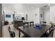 Open dining room and kitchen area with dark wood table and island at 2578 Gray Wolf Pl, Castle Rock, CO 80104