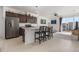 Stylish kitchen boasts stainless steel appliances, granite countertops, a breakfast bar, and seamless flow into the living area at 2578 Gray Wolf Pl, Castle Rock, CO 80104