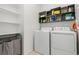 Functional laundry room featuring a washer and dryer, shelving, and modern appliances for convenience at 2578 Gray Wolf Pl, Castle Rock, CO 80104