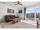 Inviting living room with a leather sofa and a sliding glass door at 2578 Gray Wolf Pl, Castle Rock, CO 80104