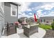 Cozy outdoor patio with comfortable seating, an umbrella, and views of the neighborhood at 2578 Gray Wolf Pl, Castle Rock, CO 80104