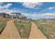 Scenic view of the community walking paths winding through the green landscape and neighborhood homes at 2578 Gray Wolf Pl, Castle Rock, CO 80104