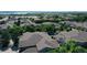Aerial view showcasing the neighborhood's rooftops and lush landscaping with mature trees at 4251 S Blackhawk Cir # 3E, Aurora, CO 80014