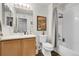 Bathroom with vanity, mirror, toilet, and shower featuring white tile and neutral decor at 4251 S Blackhawk Cir # 3E, Aurora, CO 80014