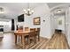 Bright dining area with a wooden table set, laminate flooring, and modern lighting at 4251 S Blackhawk Cir # 3E, Aurora, CO 80014