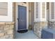 Charming front door with stone accents, a welcoming mat, and a cute teddy bear at 4251 S Blackhawk Cir # 3E, Aurora, CO 80014