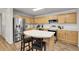 Modern kitchen with stainless steel appliances, island seating, and lots of cabinet space at 4251 S Blackhawk Cir # 3E, Aurora, CO 80014