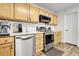 Modern kitchen with stainless steel appliances, wood cabinets, and a white countertop at 4251 S Blackhawk Cir # 3E, Aurora, CO 80014