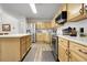 Well-equipped kitchen with wooden cabinetry, an island and modern appliances at 4251 S Blackhawk Cir # 3E, Aurora, CO 80014