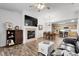 Inviting living space with a fireplace, TV, and hardwood floors flowing into an adjacent dining area at 4251 S Blackhawk Cir # 3E, Aurora, CO 80014