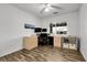 Home office space with natural light, built-in desk and shelving, and laminate floors at 4251 S Blackhawk Cir # 3E, Aurora, CO 80014