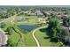Aerial view of community park with walking trails, ponds, and lush green landscape at 4251 S Blackhawk Cir # 3E, Aurora, CO 80014