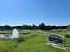Scenic view of Carson Park featuring lush greenery, a pond, and a welcoming sign at 4251 S Blackhawk Cir # 3E, Aurora, CO 80014