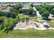 Aerial view of the community playground surrounded by trees and green space at 4251 S Blackhawk Cir # 3E, Aurora, CO 80014